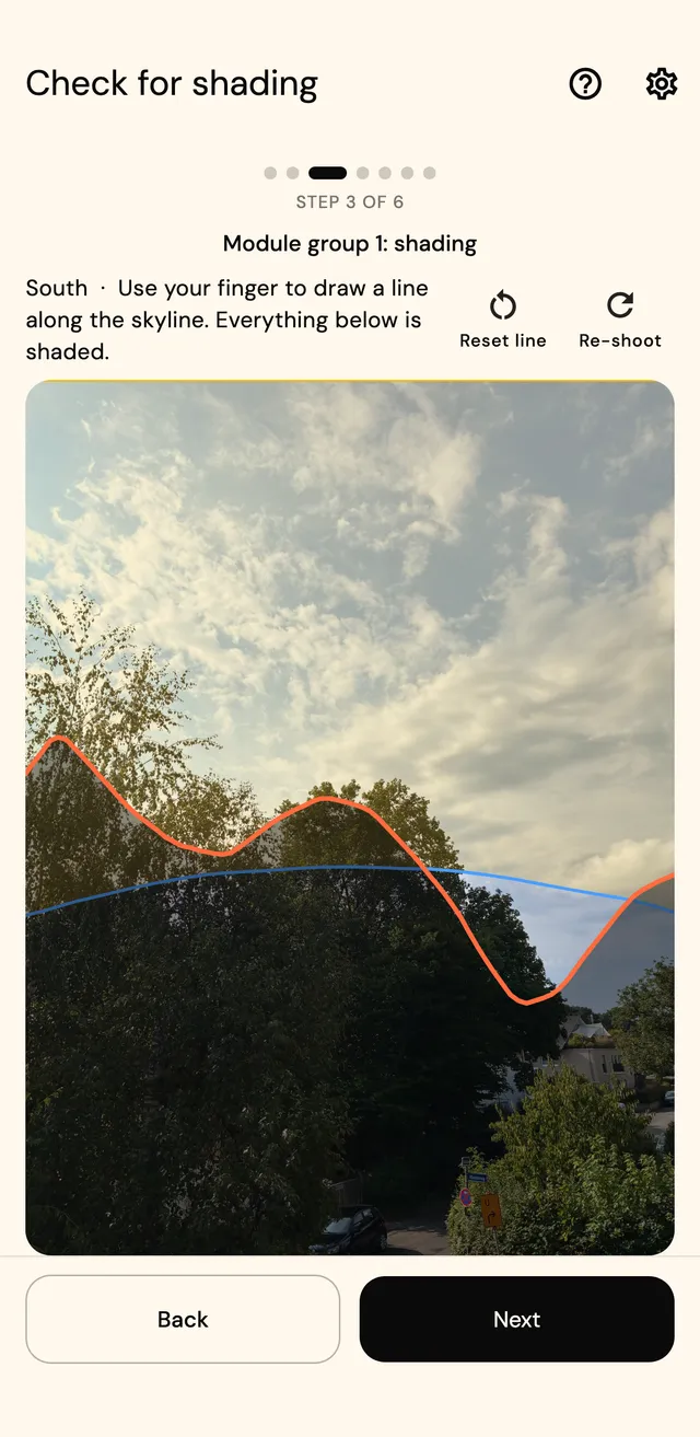 Horizon photo with the horizon line drawn in orange and the sun path in blue